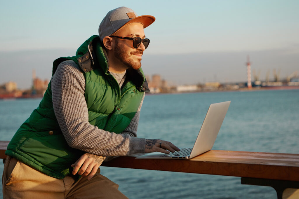 modern young entrepreneur on laptop at beach